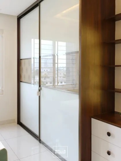 Another view of the sliding wardrobe, showing how it fits perfectly into the space next to the window, providing ample storage without blocking natural light.