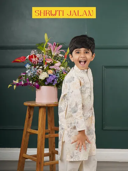 The joy on this little boy's face says it all. He's wearing my off-white printed kurta, a comfortable and stylish choice that lets him play and celebrate freely.