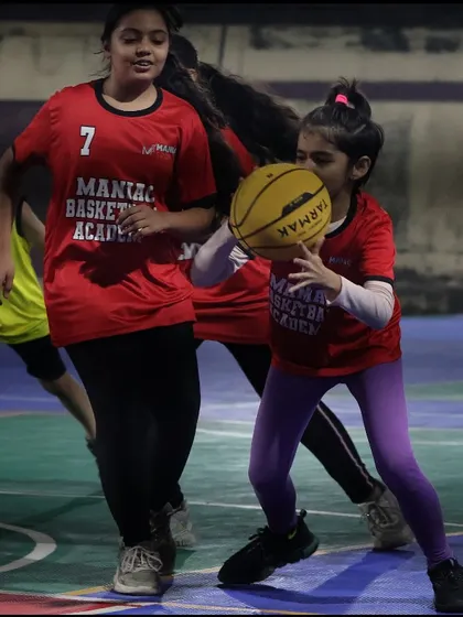 Two young girls work together during a drill. We foster a supportive environment where players push each other to be better.