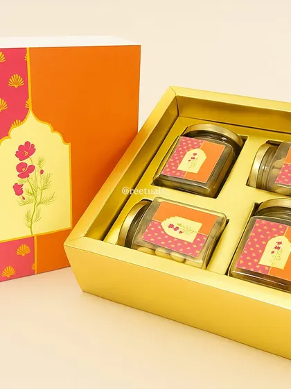 This bright and cheerful dry fruit box is a classic Diwali gift. I designed the packaging with vibrant pink and orange floral motifs, and the box contains four glass jars ready to be filled with your choice of nuts and treats.