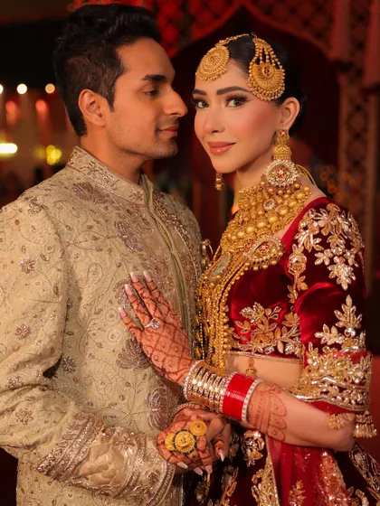 A beautiful moment between the happy couple. Her makeup was designed to look stunning in the warm evening lights of the reception, with defined eyes and radiant skin.