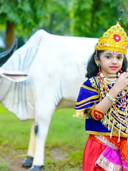 Another great shot from the Janmashtami series, capturing the full costume and the festive, pastoral theme.