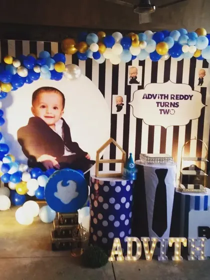 Advith Reddy turned two with this cool Boss Baby themed party. We created a dynamic setup with a black and white striped backdrop, a blue and gold balloon arch, and a large light-up number "2" to celebrate the milestone.