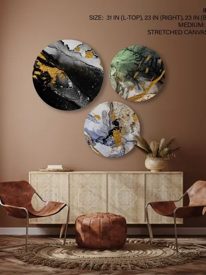 This set of three circular stretched canvas prints features trendy abstract swirls with gold, black, and green accents. The fluid, marble-like patterns create a sense of luxury and dynamic movement.