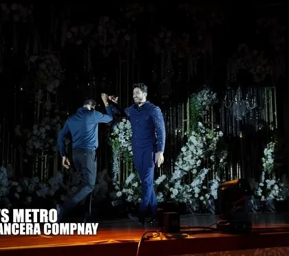 The beginning of a legendary dance battle. Two performers face off in this retro vs. metro themed act, set against a stunning floral backdrop.