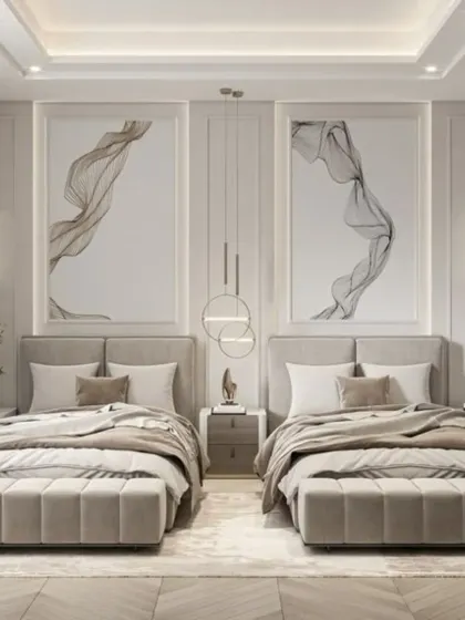 This shared bedroom has a sophisticated, hotel-like feel with its neutral tones and abstract art. The identical upholstered beds and benches provide a clean, symmetrical look suitable for older children or guests.