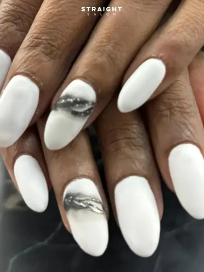 A close-up of the smoky glitter accent nail. The effect is created by blending black polish with silver glitter for a unique, textured look.