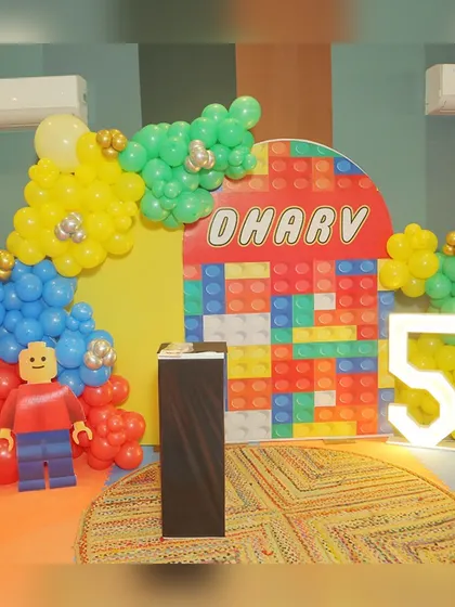 The amazing LEGO-themed decor for Dharv's 5th birthday, featuring a colorful brick backdrop and a giant LEGO man made of balloons.