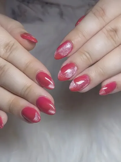 A lovely red manicure with a "cat eye" effect creating a silver shimmer in the center of each nail.