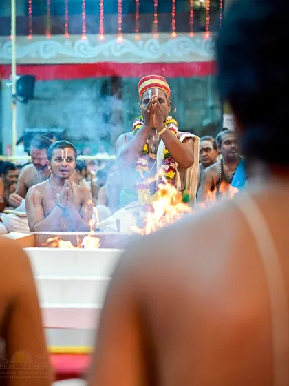 A priest offers prayers to the sacred fire during the Maha Sudarshan Homa. The rising smoke is believed to carry the offerings and prayers to the divine.