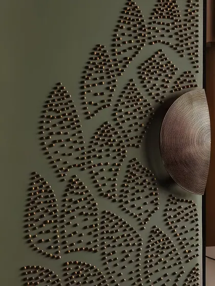 Some spaces are meant to be discovered in the details. This close-up shows a custom cabinet door with intricate brass stud detailing, a whisper of the craftsmanship and texture that defines our work.