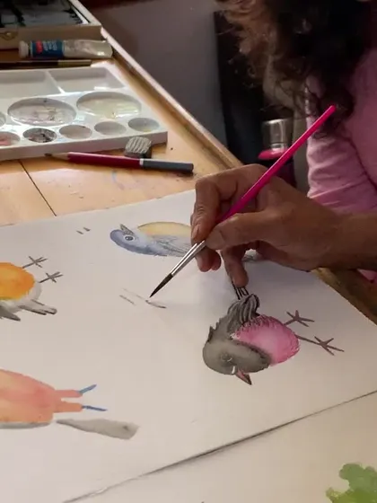 A student practices painting small, colorful birds in watercolor. Nature provides endless inspiration, and our courses help you capture its beauty.