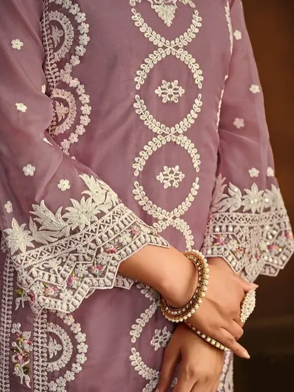 This mauve organza Anarkali is soft and dreamy. The detailed thread embroidery on the hem and sleeves gives it a delicate, handcrafted feel.
