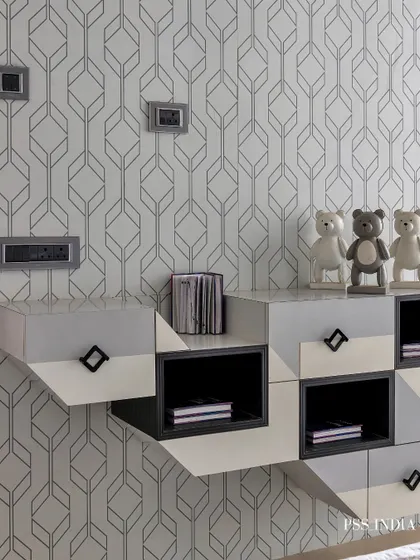 A close-up of the geometric storage unit, styled with whimsical bear figurines. This detail shows how I inject personality and playfulness even into a sophisticated, monochrome design scheme.