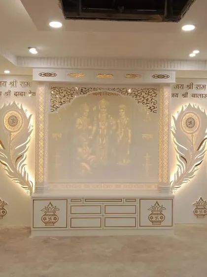 A grand mandir design in Corian finish, featuring Lord Ram's family and peacock feather motifs. The entire unit is backlit for a divine glow.