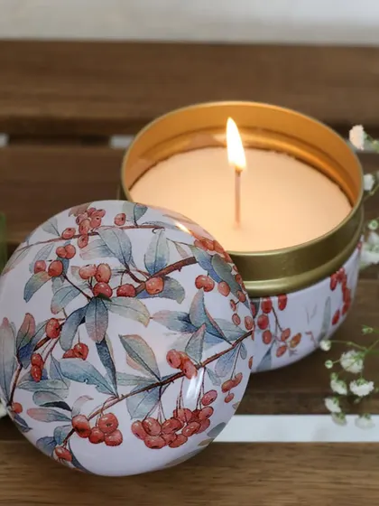 A minimal scented candle in a tin with a delicate berry print. Housed in a sleek, understated jar, it’s a quiet statement of elegance for any corner of your home.