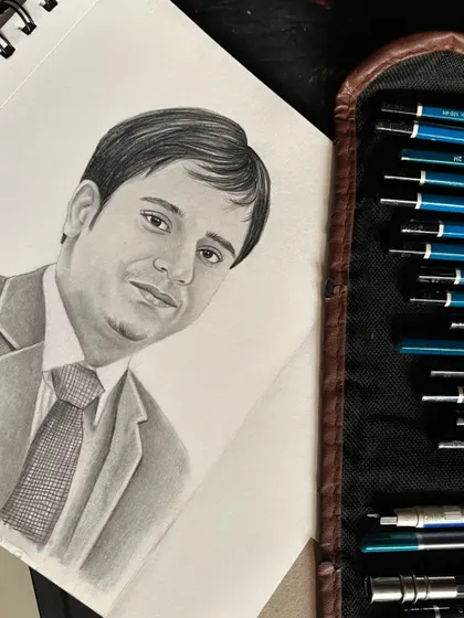 The portrait seen on my sketchbook next to my set of drawing pencils, giving a glimpse into the tools I use for my commissioned artwork.