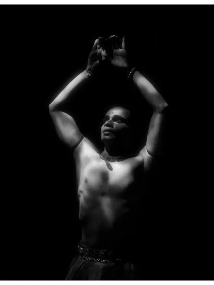 A black and white shot of me in 'Naga Mandala', with arms raised towards the light. This pose signifies a moment of surrender or appeal.