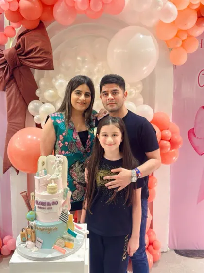 The birthday girl and her family posing with the amazing cake.