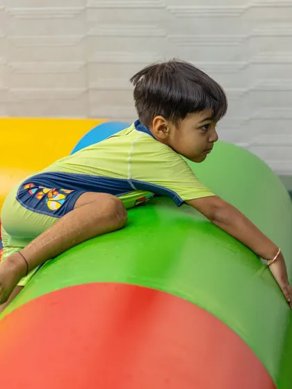 Conquering the inflatable water obstacle course is a fun challenge for our energetic guests.