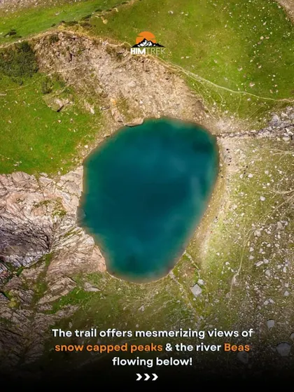 An aerial view of the stunningly clear, turquoise water of the Beas Kund glacial lake.