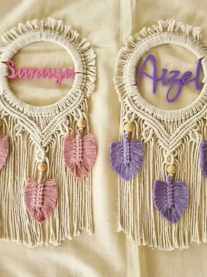 A lovely pair of macrame name hangings for 'Sanaya' and 'Aizel'. These are perfect for a shared kids' room, with each piece customized in their favorite color.