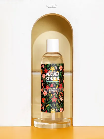 A duplicate of a previous shot, showing the body spray framed in a white arch. This composition is effective for drawing attention directly to the product.