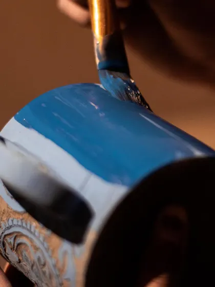 The process of painting on underglaze before carving. This layer of color is what you'll reveal as you scratch away your design.