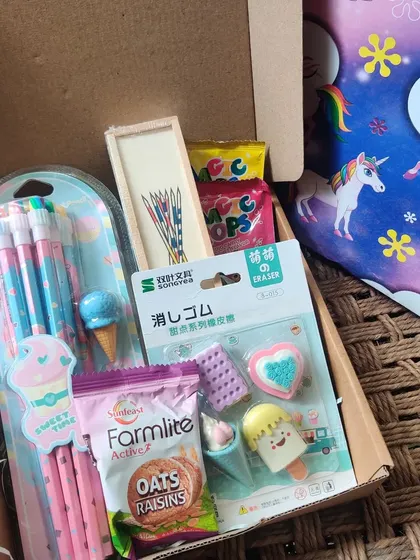 A look inside one of my custom kids' hampers. This one was created as a return gift and includes a pencil set, cute ice cream-themed erasers, biscuits, and other small treats.