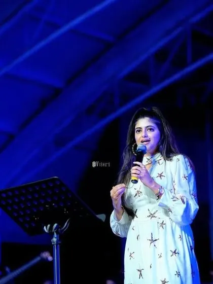 Addressing the audience during a show. I love to share stories and connect with people through music.