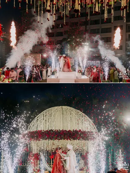 The grand finale of the varmala, with the couple framed by a dome of red roses and a spectacular display of cold pyros.