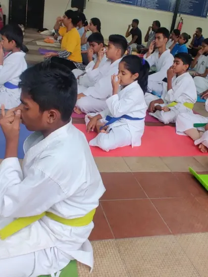 Students practicing Anulom Vilom, a breathing exercise, during a yoga session. We teach mindfulness and breath control to help our students stay calm and focused under pressure.