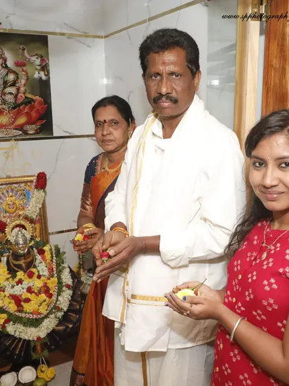A family poses together in their home's pooja room during a housewarming ceremony. We capture both the formal rituals and the proud family portraits.