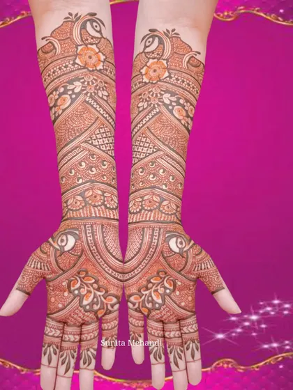 A symmetrical design featuring peacock heads and floral patterns. The mirroring effect on both hands creates a very balanced and aesthetically pleasing look.