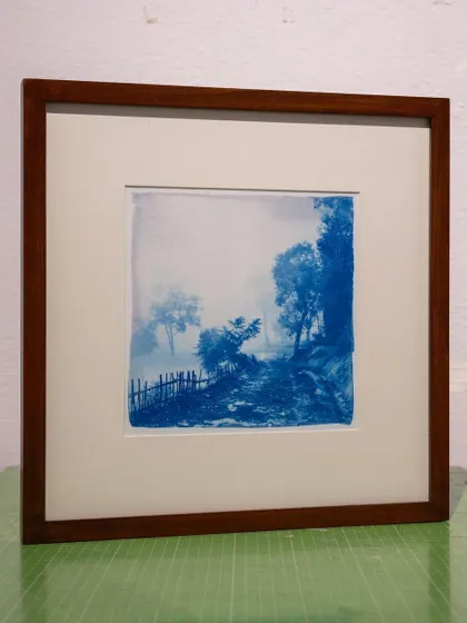 A framed cyanotype of a misty, rural path. For this commission, we tweaked our chemistry with vinegar to extend the tonal scope and achieve more delicate mid-tones.