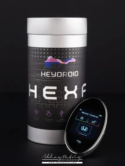 A sleek and modern product shot for a smart car key. The dark, clean background and focused lighting highlight the product's design and technology, positioning it as a high-end gadget.