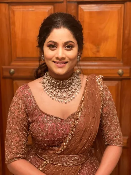A beautiful reception look. The client is wearing a dusty rose lehenga, and the makeup is soft and romantic to match.