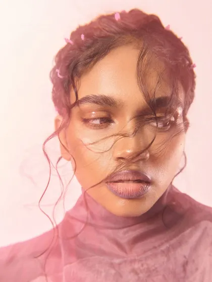 A soft, romantic close-up for Ponny Mag, with wind-swept hair and a gentle expression.