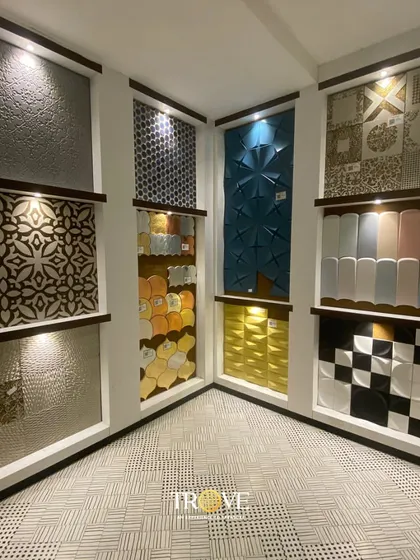 This corner of my showroom is dedicated to showcasing unique designer tiles. It features a mix of 3D patterns, colorful mosaics, and textured surfaces, giving you a taste of the creative possibilities for your walls.