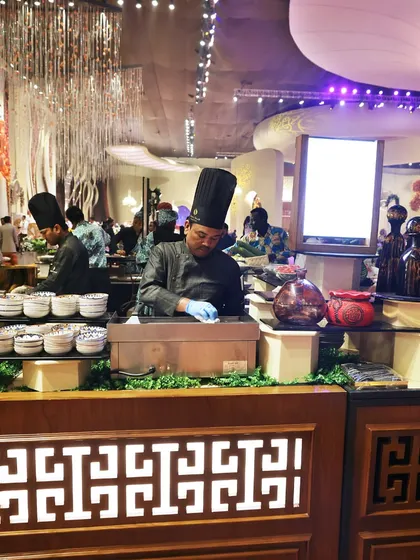 A wide shot of our chefs at a Pan-Asian live station. The setup is clean, professional, and designed for efficient service at large-scale events.