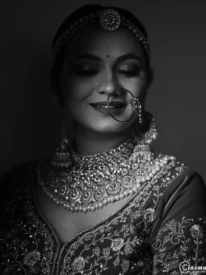 A close-up black and white portrait of the bride with her eyes closed, capturing a moment of quiet happiness and contentment.