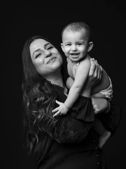 A mother's love, captured in a classic black and white portrait. Her expression and her baby's happy face say everything.