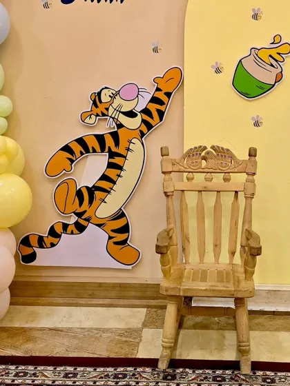 A close-up of the Tigger cutout and the special wooden chair for the birthday boy from the Winnie the Pooh setup.
