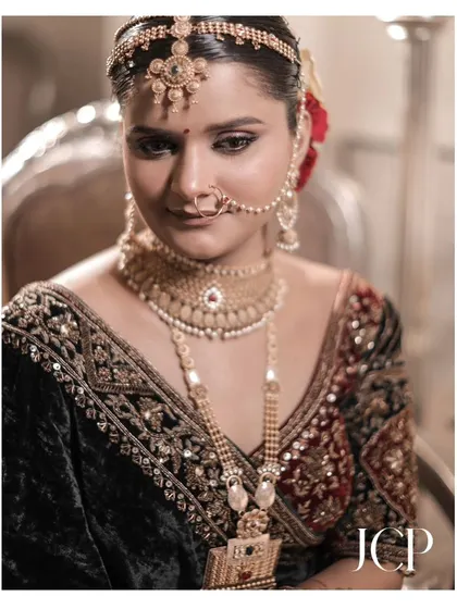 A close-up portrait of a bride in a traditional velvet lehenga at Hotel Chomu Palace, Jaipur.
