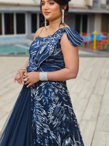 A side view of the client in the blue outfit, showing the intricate silver work.