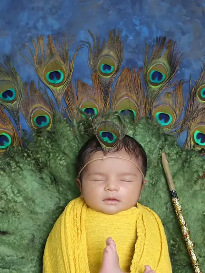Our little Krishna theme, featuring a newborn wrapped in yellow and adorned with a peacock feather. This is a beautiful way to celebrate faith and tradition.
