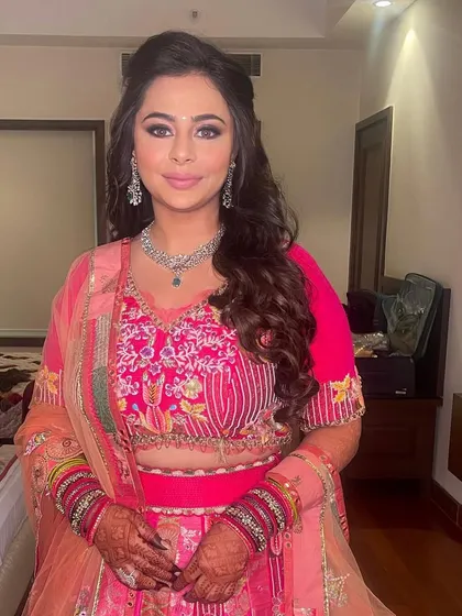A half-up, half-down style with soft waves, perfect for a sangeet or engagement party.