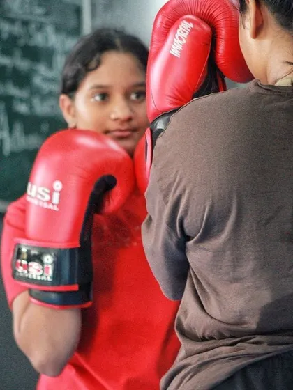 Learning to read an opponent starts with drills like this. One student watches for openings while the other maintains her guard.