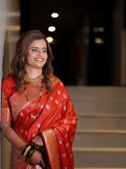 A candid shot of the bride enjoying a moment during her reception, beautifully lit and full of warmth.