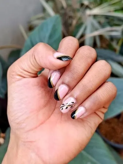 A different angle of the custom black French and floral art nails, showing how the design flows across the different nails.
